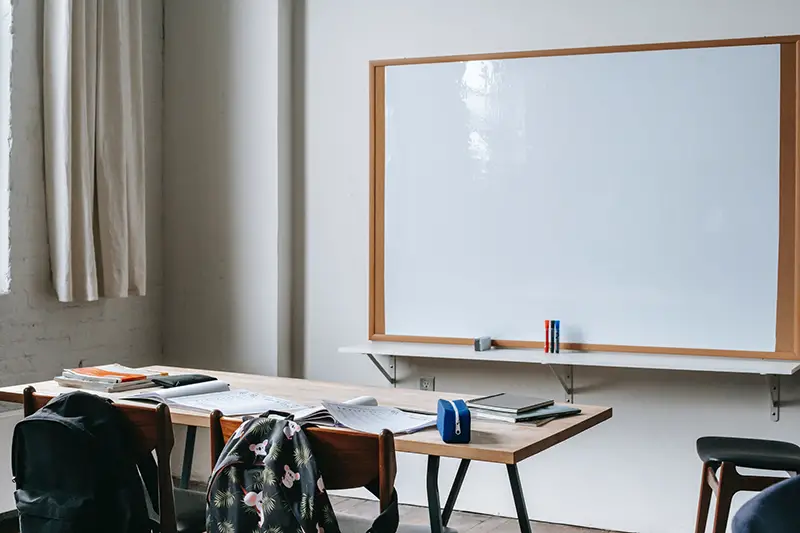 School bench with stationery in classroom