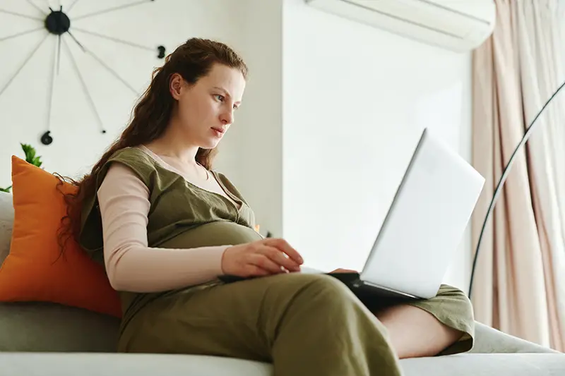 woman in brown shirt and brown pants sitting on the couch