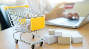 Yellow toy cart and tiny cardboard boxes
