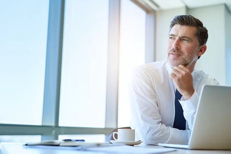 Business executive sitting at his office desk