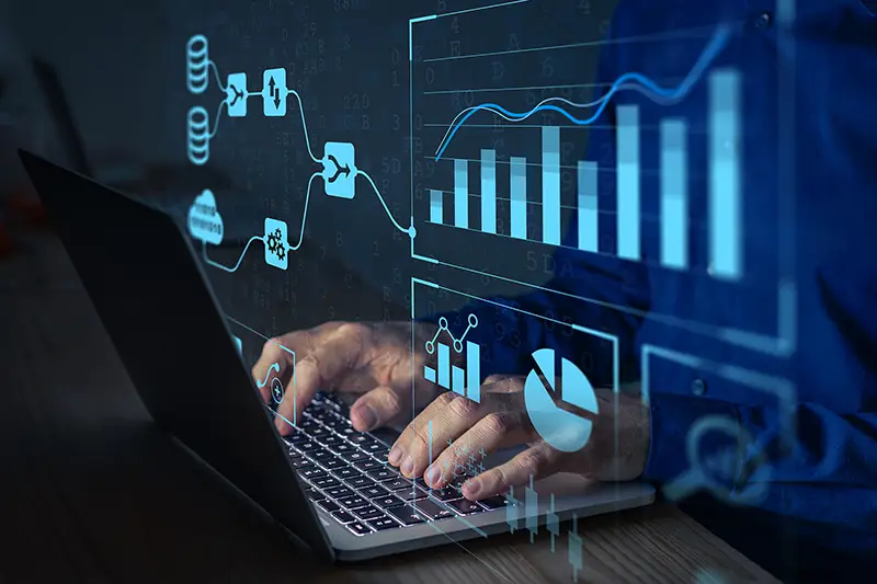 Analyst working with Business Analytics and Data Management System on computer