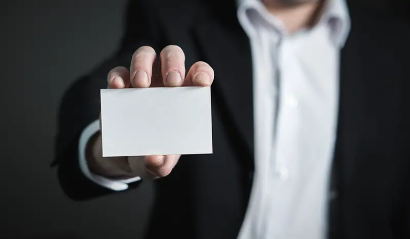 Man holding white square blank card
