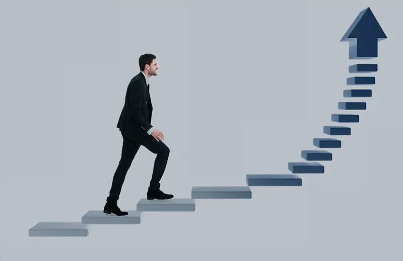 Businessman up the staircase over white background