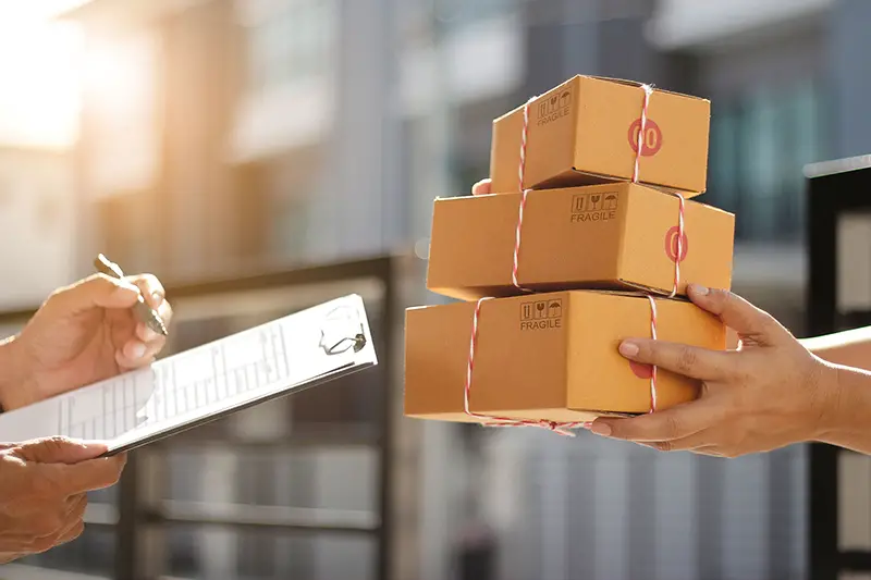 Delivery man holding parcel boxes