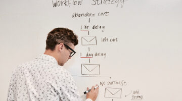 man writing on white board