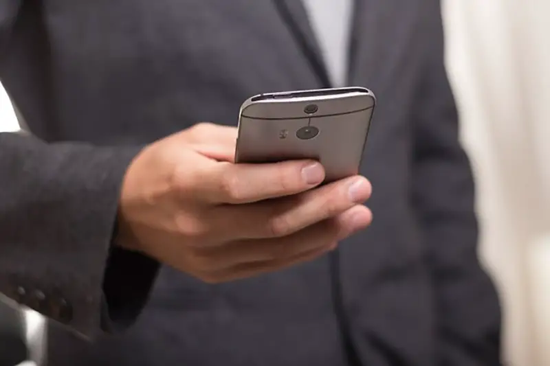 Man in suit using smart phone