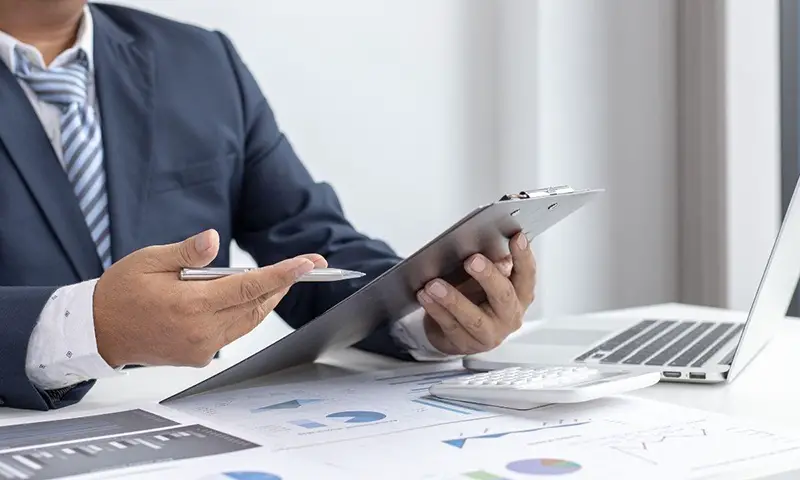 Businessman holding a gray clipboard