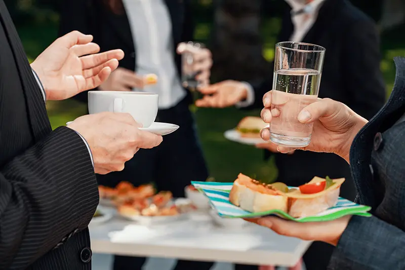 Closeup of Man and woman holding foods during buciness events