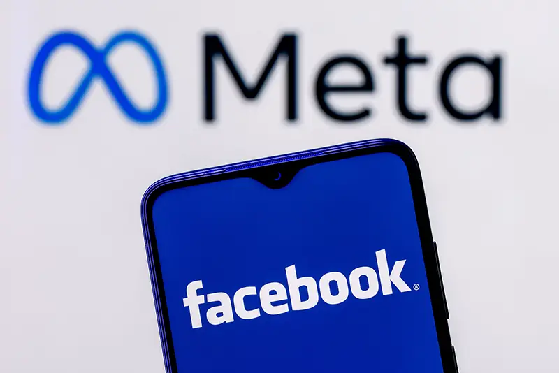 Smartphone with Facebook logo on the background of Meta logo
