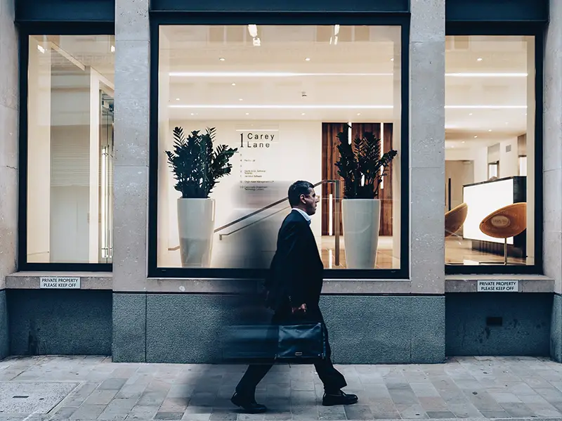 Man in black suit walking in gesture