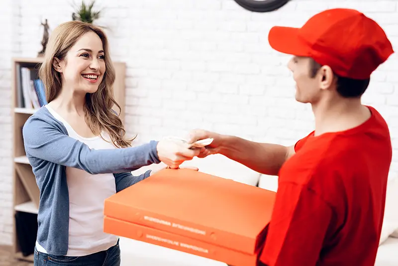 A man works on the delivery of pizza