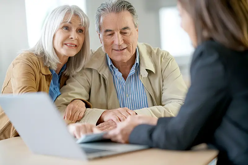 Senior couple meeting financial adviser for investment