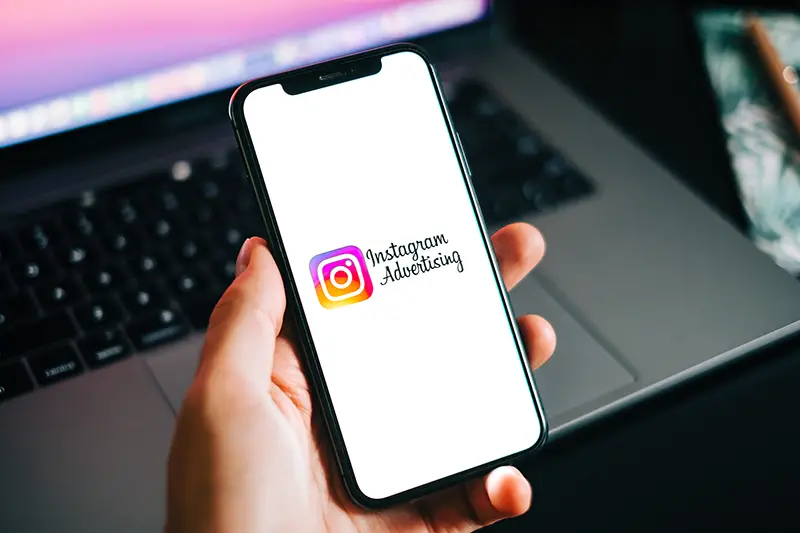 Instagram ads logo on the smartphone screen
