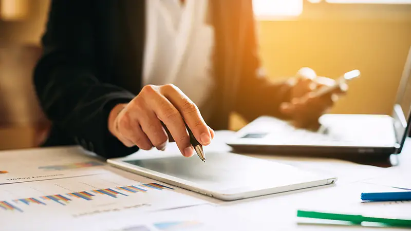 businessman working on project for analyzing company financial report balance statement with documents graphics at modern office space