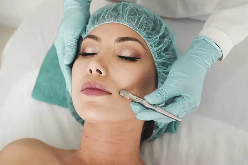 Woman doing a liposuction on her face