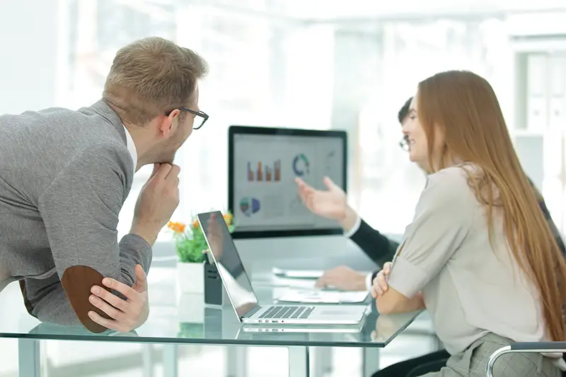 business team works with project statistics data using a laptop