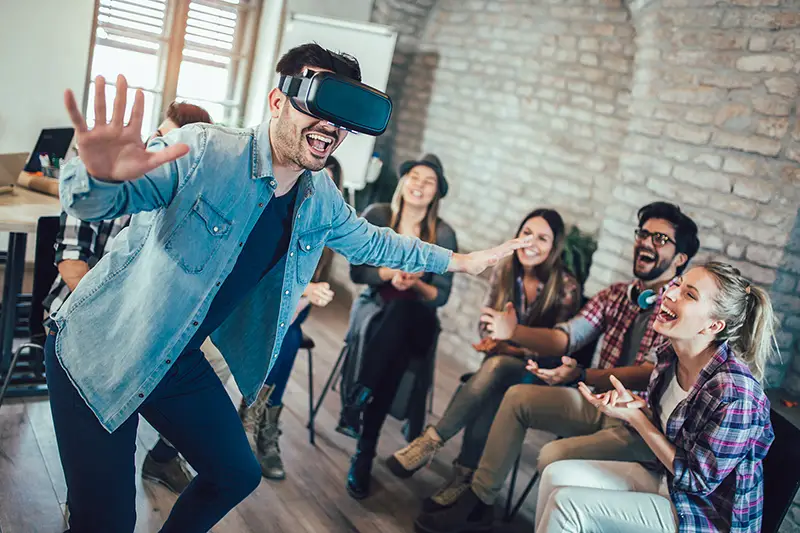 Business people making team training exercise during team building seminar using VR glasses