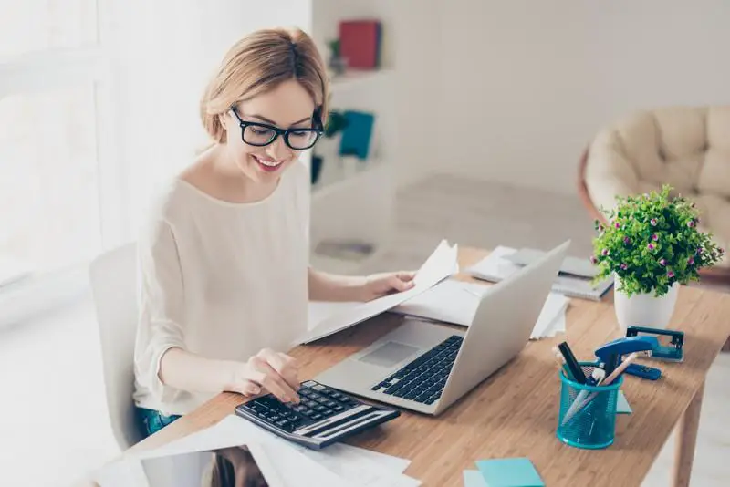 Young female accountant working in front of her desk