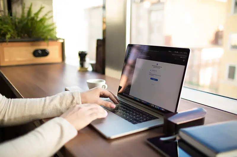 Woman typing on laptop keyboard