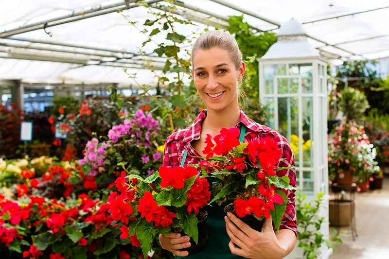 Female florist gardener in flower shop