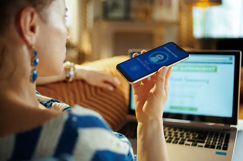 Woman holding her mobile phone using a speech command