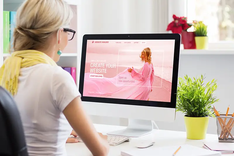 Woman creating her own website on computer