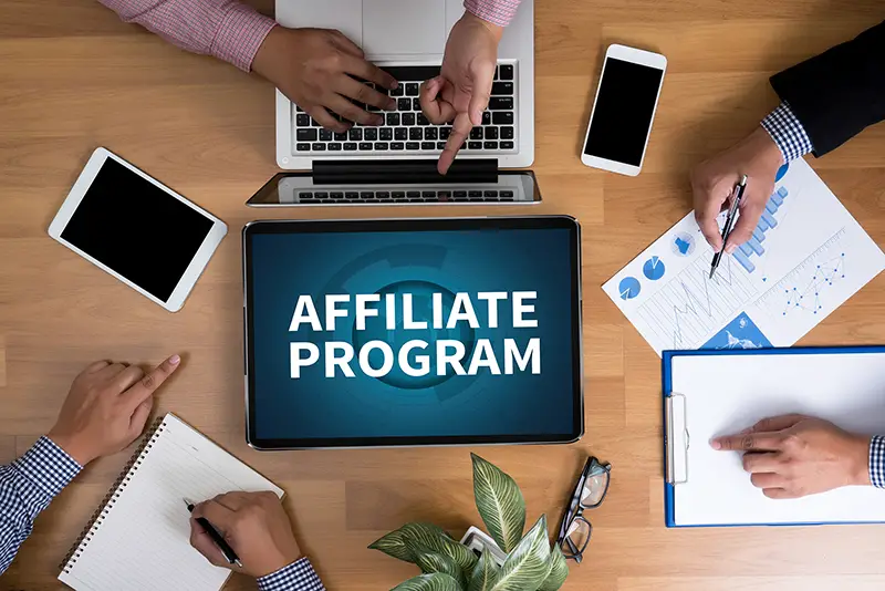AFFILIATE PROGRAM Business team hands at work with financial reports