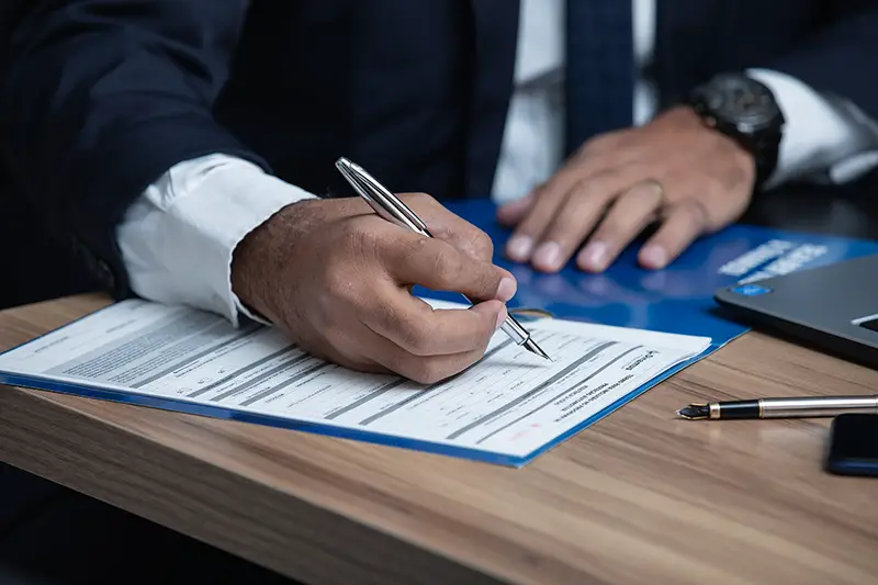 man writing on a white paper