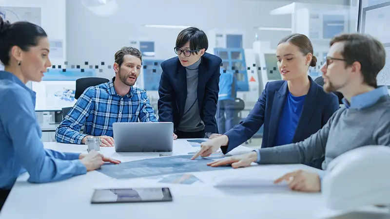 Multi Ethnic and Diverse Team of people sitting at conference table