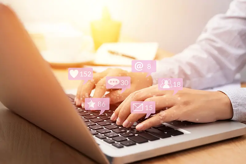 Person using notebook computer laptop for social media interactions