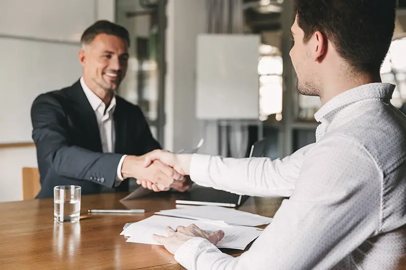 Male recruiter handshaking to a male applicant