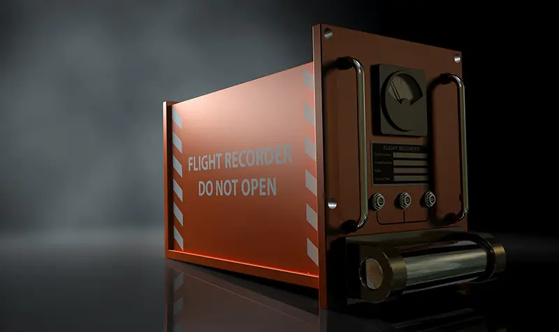 A regular aviation flight recorder black box painted in orange