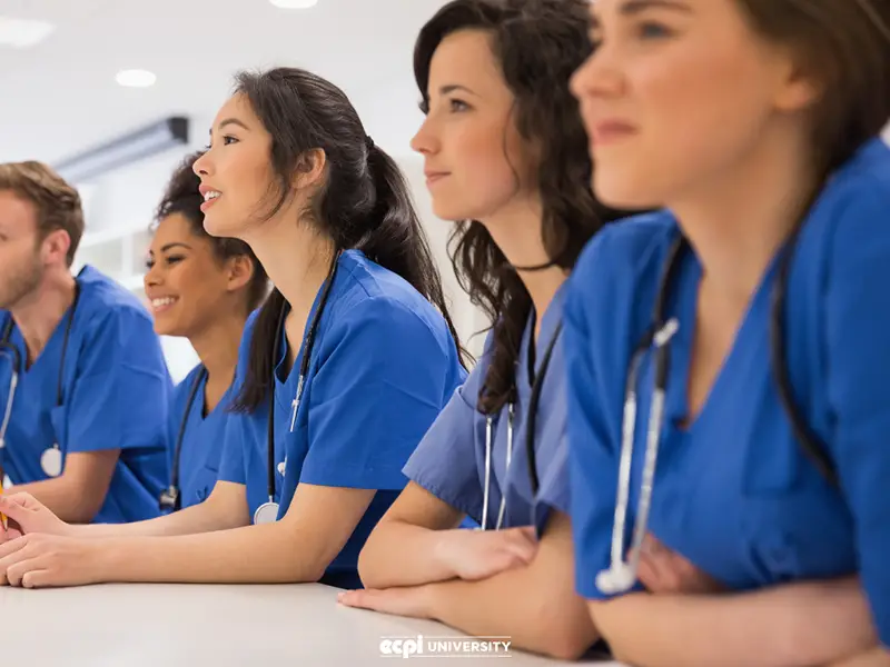 Nursing student wearing blue uniform