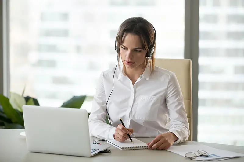 Young female translator working on her laptop