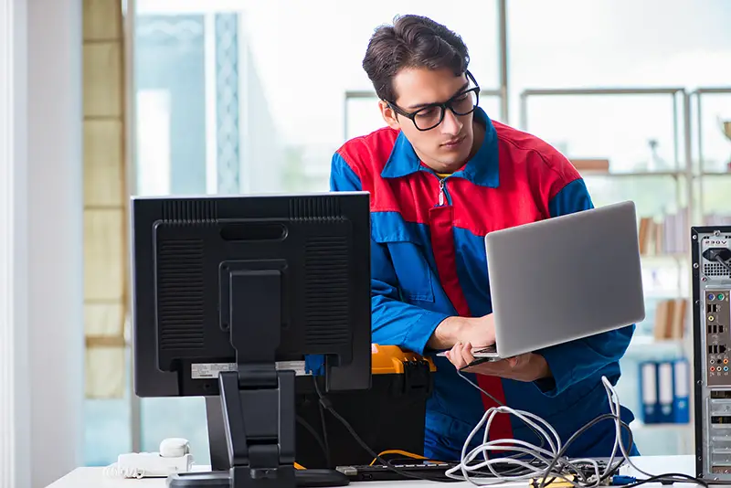 Computer repairman working on repairing computer