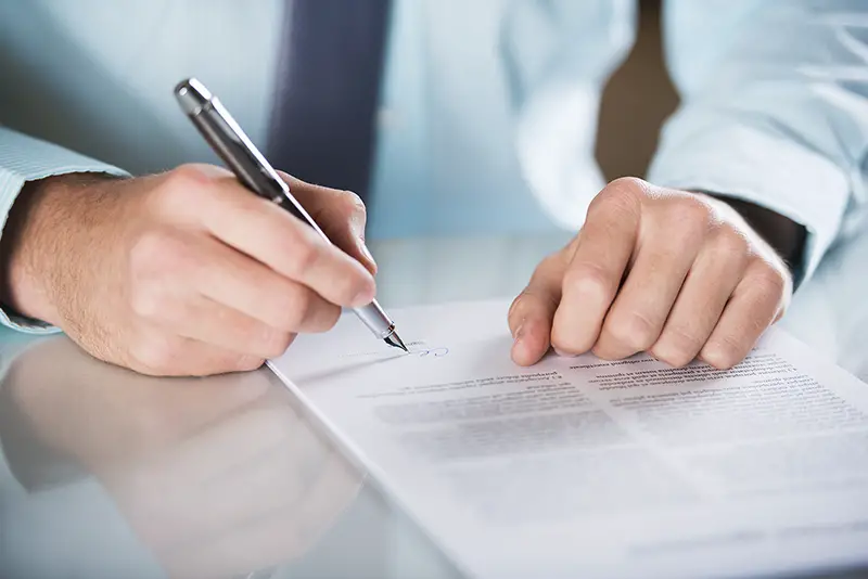 Businessman is signing a contract