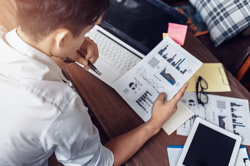 Businessman hold pen and working calculate data