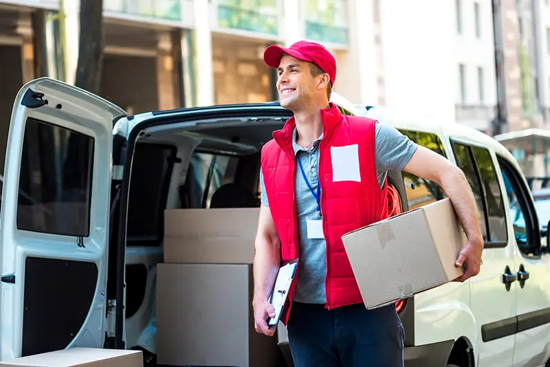 Courier Delivering Package By Van