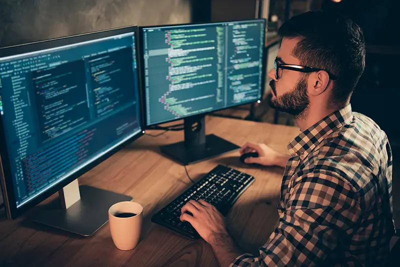 Man wearing eyeglasses working on his computer