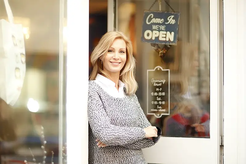 woman standing in front of small vintage store