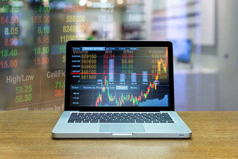 Stock exchange market trading graph over the screen of computer laptop