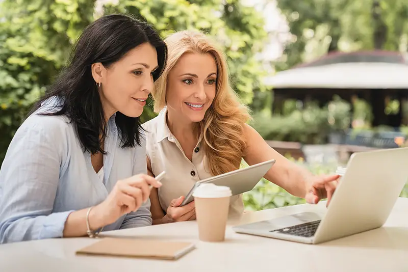 Two caucasian middle-aged businesswomen working together