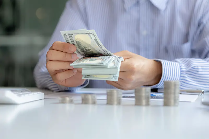 Businessman counting dollars