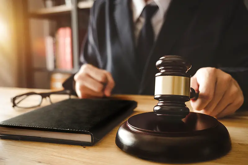 Male judge in a courtroom with the gavel