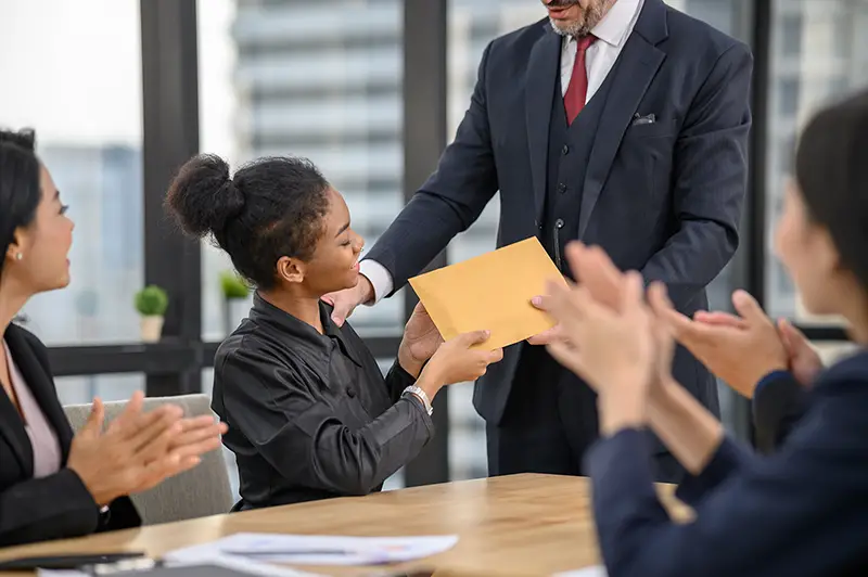 Woman employee receive incentive from her boss