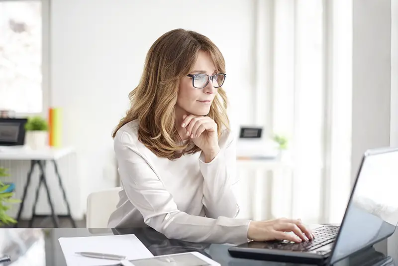 businesswoman working on laptop in her workstation