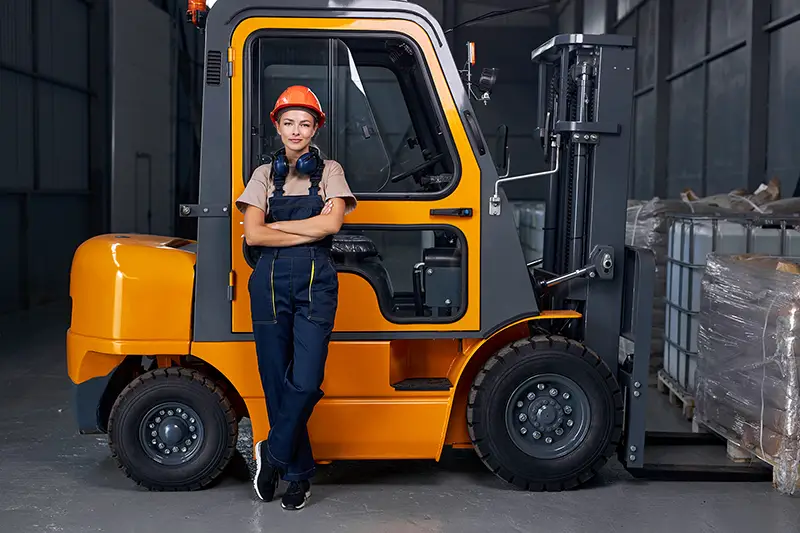 woman labor worker near forklift driver in industry factory