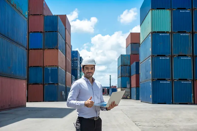 Shipping officer holding laptop