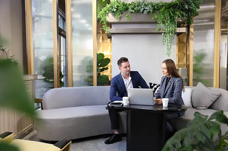 Business people working while sitting on the gray couch