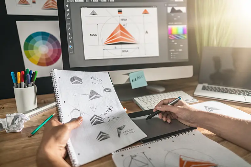 Graphic designer drawing sketches logo design